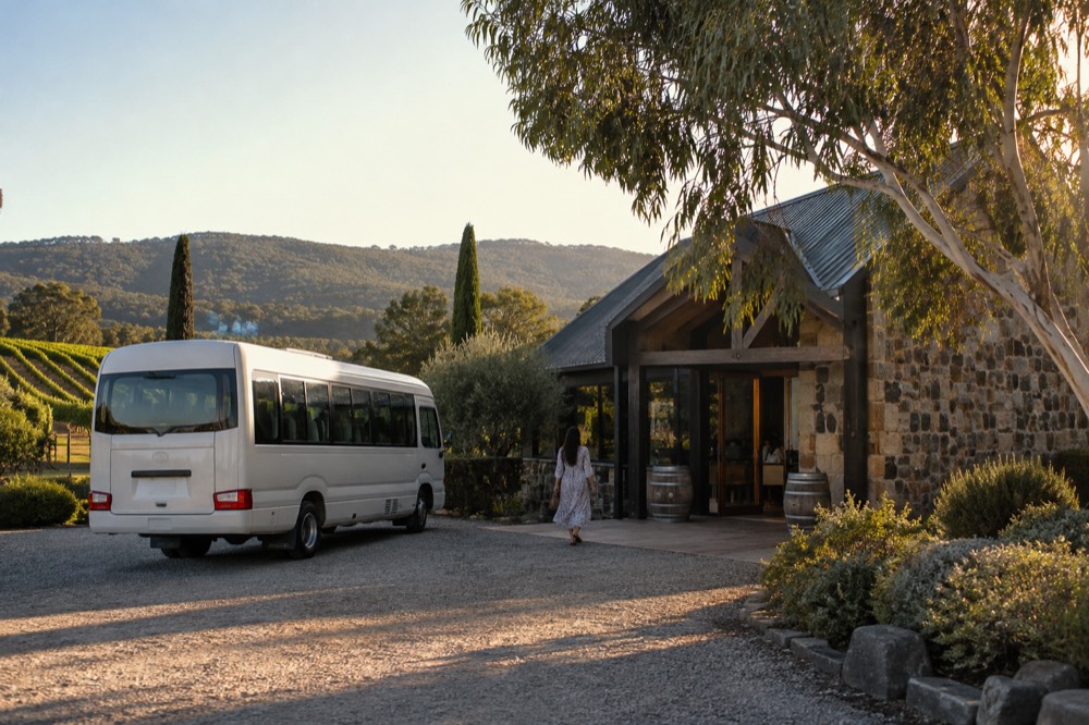 A small tour van parked beside a cellar door entrance