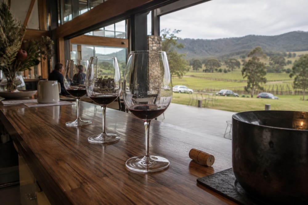 A tasting flight of red wines on a cellar door counter